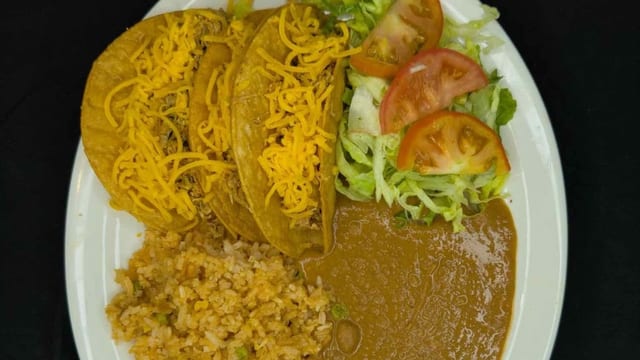 35. 3 Crispy Beef Tacos, Spanish Rice, Refried Beans, and Salad.